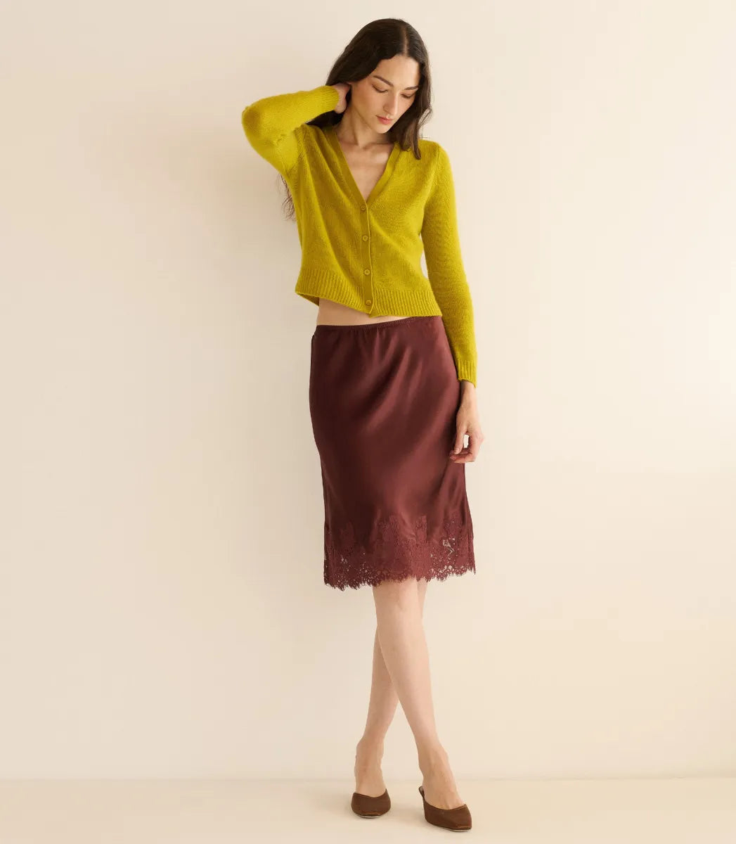 Crafted from luxurious silk satin, the Elowette Skirt in Cafe Brun by Doen features a bias-cut design that drapes beautifully for a refined silhouette. Its scalloped elastic high waist ensures both comfort and fit, while the delicate floral lace trim at the hem adds subtle sophistication. This midi-length skirt seamlessly transitions between casual and formal settings, making it a versatile addition to your wardrobe. Pair with a fitted top to create an expert polished look suited for day-to-night wear.