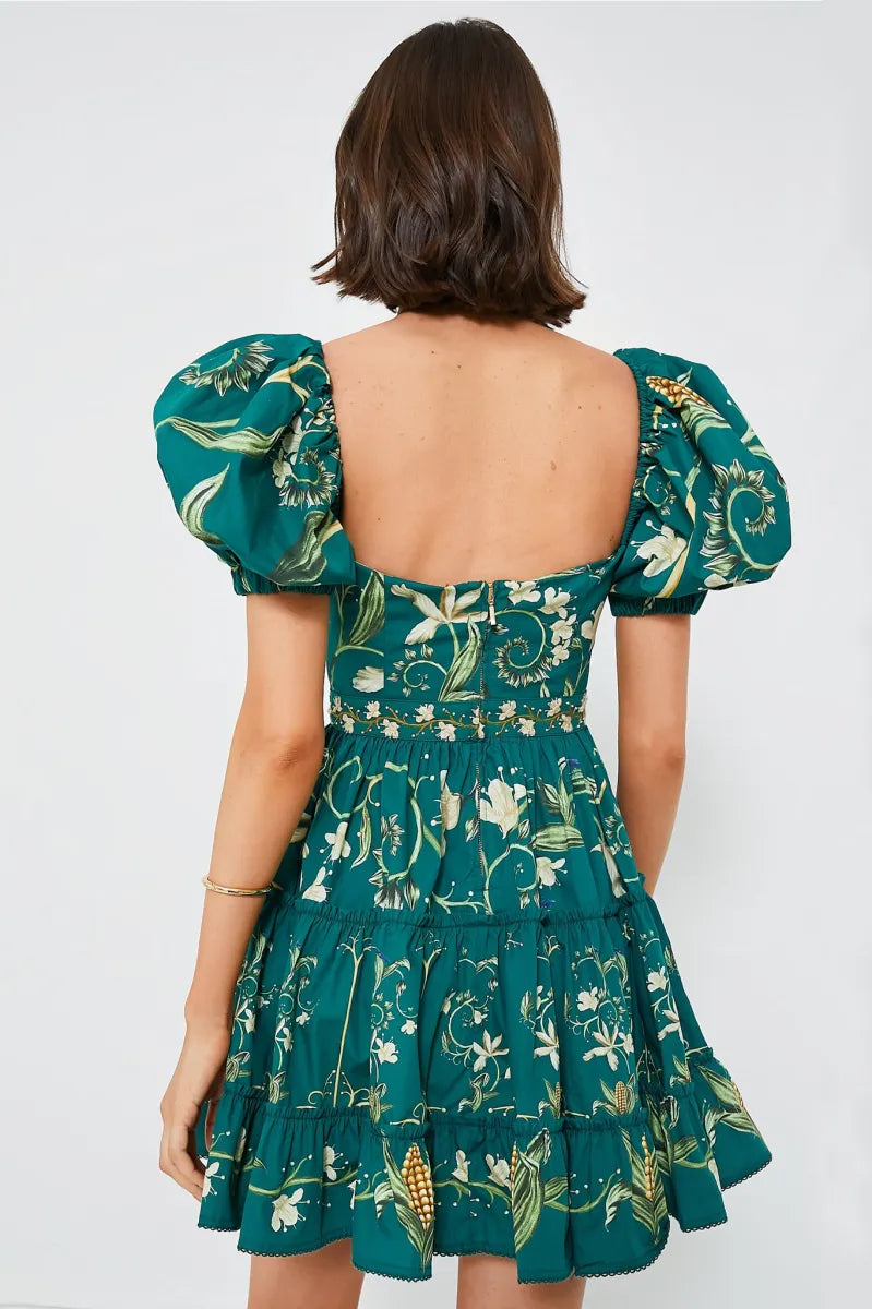The Esmeralda Manzanilla Mini Dress combines effortless style with comfort, crafted from breathable 100% cotton poplin. Its adjustable deep-v neckline with a delicate drawstring ensures a custom fit, while the hand-embroidered waistline adds a refined artisanal touch. Featuring a concealed back zip for a seamless silhouette, this dress is perfect for warm days and tropical evenings. Elevate your look by pairing it with espadrilles or heels and statement jewelry for a polished, vibrant outfit.
