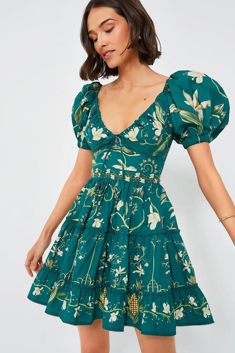 The Esmeralda Manzanilla Mini Dress combines effortless style with comfort, crafted from breathable 100% cotton poplin. Its adjustable deep-v neckline with a delicate drawstring ensures a custom fit, while the hand-embroidered waistline adds a refined artisanal touch. Featuring a concealed back zip for a seamless silhouette, this dress is perfect for warm days and tropical evenings. Elevate your look by pairing it with espadrilles or heels and statement jewelry for a polished, vibrant outfit.