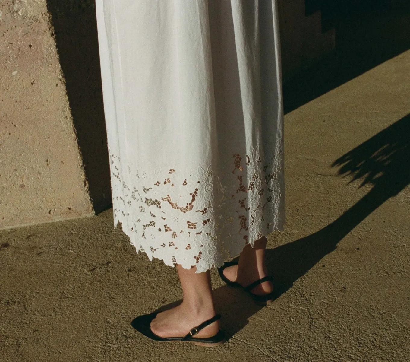 Crafted from organic cotton poplin, the Ellen Dress in Salt showcases expert detailing with a square neckline featuring hand-placed floral embroidery cutwork. Thick straps ensure comfort and support, while the ankle-length hem is enhanced by clustered pintucks and shirring, adding subtle texture. This breathable maxi dress combines refined elegance with effortless wearability, making it an excellent choice for warm-weather occasions that call for both style and comfort.
