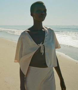 Indulge in timeless elegance with the Elowen Skirt from Doen. This luxurious silk satin skirt features delicate scallop elastic trims and a bias-cut midi design adorned with intricate contrast lace. Its high-waisted silhouette adds a touch of '90s nostalgia, perfect for pairing with the Chantal Top for an elevated matching set. From day to night, embrace sophistication with the Elowen Skirt.