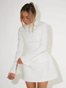 Introducing the Split Sleeve Mini Dress - the perfect addition to your winter wardrobe. With a high neck and signature cinched waist, this crisp white dress exudes sophistication. The discreet slit on the long sleeves adds a touch of elegance, while the flap pockets offer functionality. From dinner parties to engagement celebrations, this dress makes a statement.