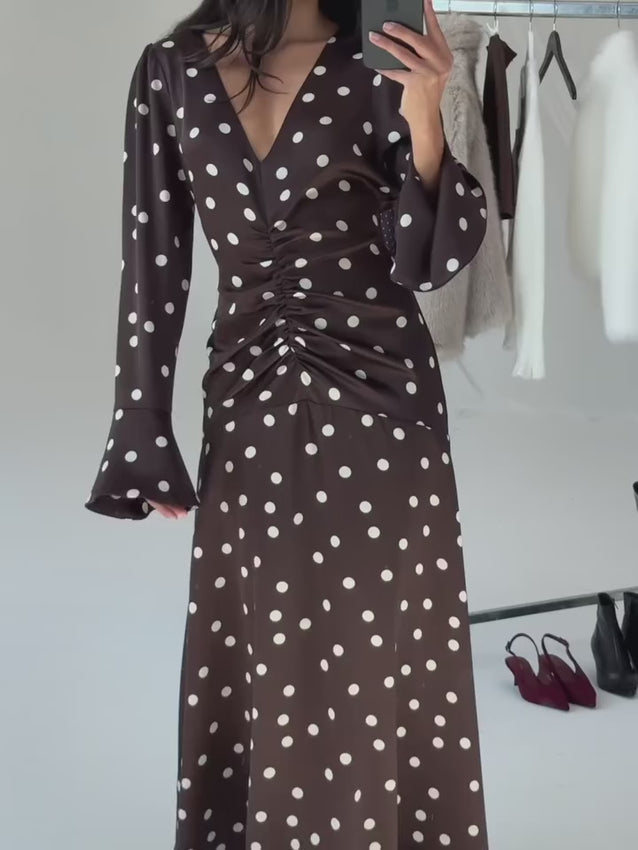 Sophisticated satin midi dress featuring a lustrous finish and refined aesthetic. The center ruching creates a flattering silhouette, while trumpet sleeves add movement and grace to the overall look. A side zipper ensures effortless dressing, and a delicate neck button provides the perfect finishing touch. Crafted from woven matte satin that drapes beautifully, this dress is ideal for special occasions and formal events.