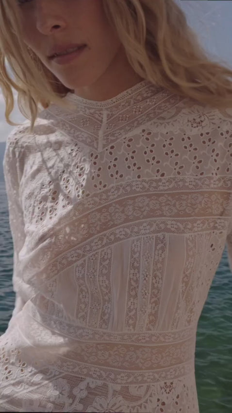 Inspired by Edwardian elegance, the Orelie Maxi Dress captures timeless sophistication in lightweight organic cotton voile. This heirloom-quality piece features alternating panels of delicate floral lace, clustered pintucks, and eyelet embroidery throughout. The high V-neckline and three-quarter-length sleeves offer refined femininity, while the ankle-grazing A-line silhouette flatters every frame. A striking line of starburst buttons traces down the back, adding vintage charm and intricate detail. 