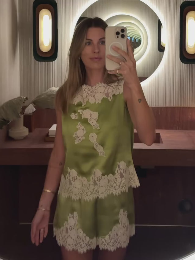 Effortless elegance meets refined craftsmanship in the Viviane Top. Crafted from luxurious buttery silk satin, this sleeveless silhouette features a relaxed, boxy cut that drapes beautifully. Delicate floral lace details grace the high bateau neckline, bodice, and hem, adding an understated touch of romance. Perfect for layering or wearing alone, this versatile piece transitions seamlessly from day to evening.