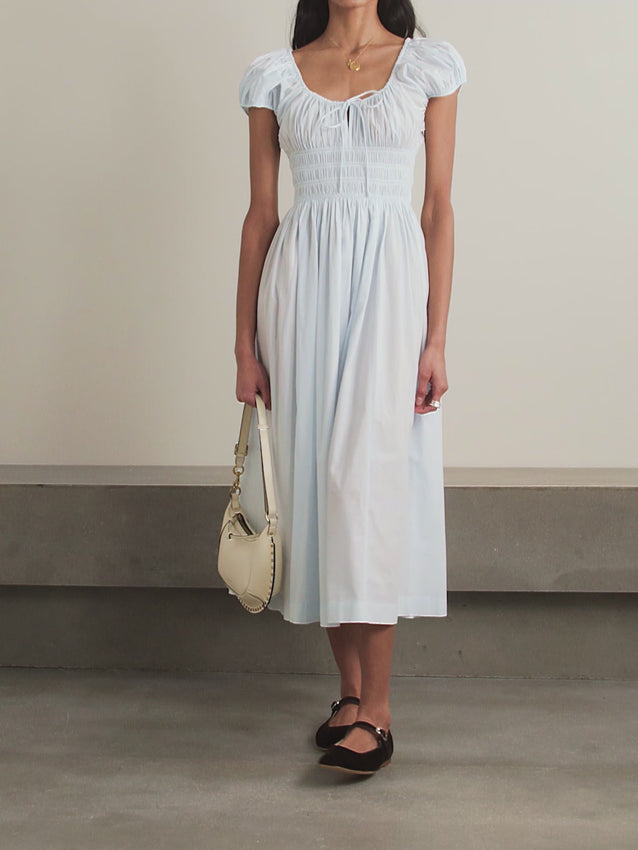 Effortless elegance meets sustainable style with the Quinn dress. Crafted from organic cotton-poplin, this midi silhouette features delicate tie detailing and subtle shirring for a flattering, feminine fit. Perfect for warm days and versatile enough to transition from brunch to evening, the Quinn dress combines timeless design with eco-conscious materials. A wardrobe essential that feels as good as it looks.