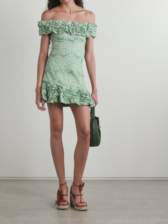 Escape to a sun-drenched garden with this enchanting Jardín mini dress by Agua by Agua Bendita. The off-the-shoulder neckline frames your shoulders with effortless elegance, while delicate ruffles add romantic movement and dimension. A vibrant floral print in soft cotton-blend fabric brings warmth and breathability, perfect for warm-weather days and breezy evenings. The relaxed mini silhouette flatters every figure, making it ideal for resort wear, casual outings, or intimate gatherings. 