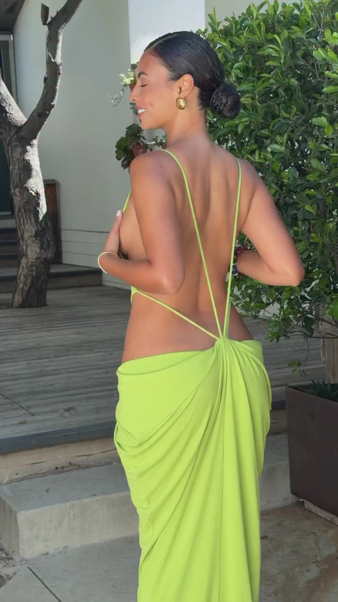 Effortless elegance meets contemporary design in this jersey gown. Crafted from lightweight fabric, it features a relaxed pull-on silhouette with striking side cut-out details and an exposed back for a modern, romantic look. The unlined construction ensures breathable comfort, making it perfect for warm-weather occasions or layering with your favorite pieces.