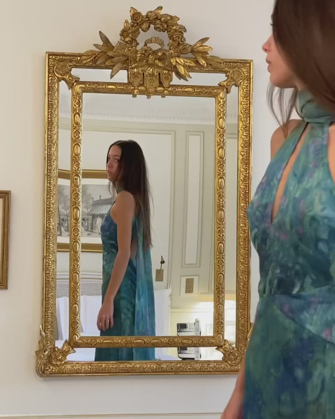 Inspired by Claude Monet's enchanting "Irises" (1914-17), this dress captures the essence of a blooming garden in soft watercolor hues. Delicate shades of blue, purple, and green blend across the fabric, evoking the impressionist master's poetic vision of nature's abundance. A wearable work of art that brings timeless elegance and artistic sophistication to your wardrobe.